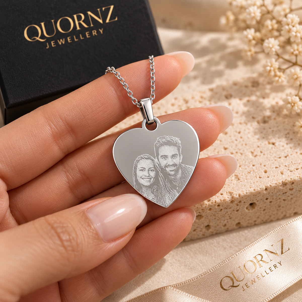 A6 personalised silver heart pendant held in hand